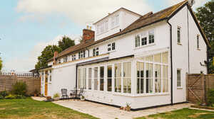 Completed extension on a white rendered house in White Waltham, with a fully glazed garden room