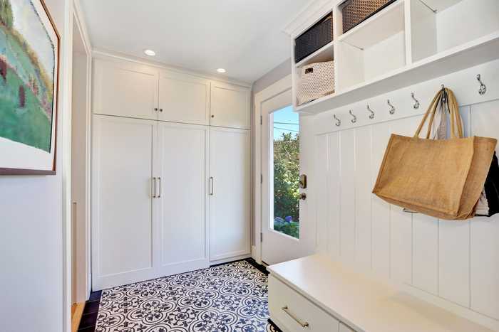 Keep clutter out of sight incorporating cupboard space in your hall space