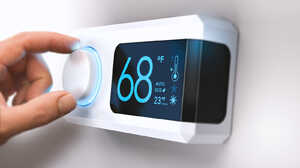 Hand adjusting a digital thermostat set to 68 degrees Fahrenheit.