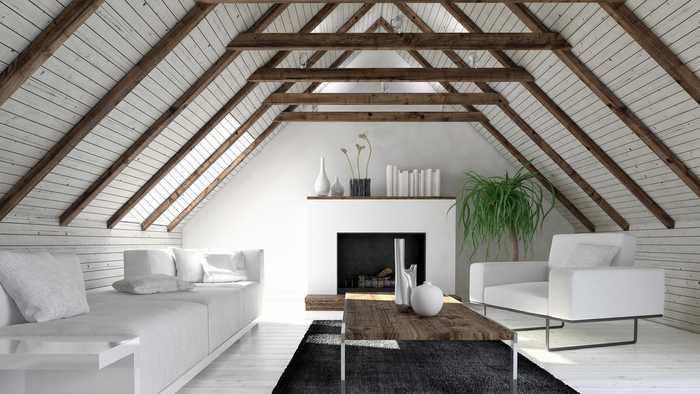 modern loft conversion with exposed beams and white furniture