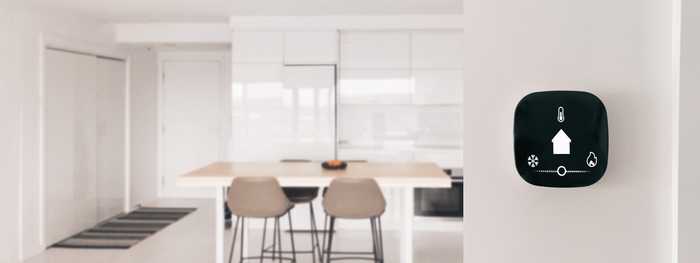 A smart thermostat mounted to the wall