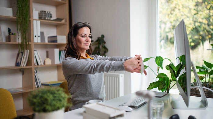 woman in a home office surrounded by plants