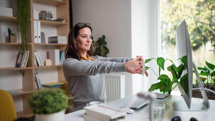 woman in a home office surrounded by plants woman in a home office surrounded by plants