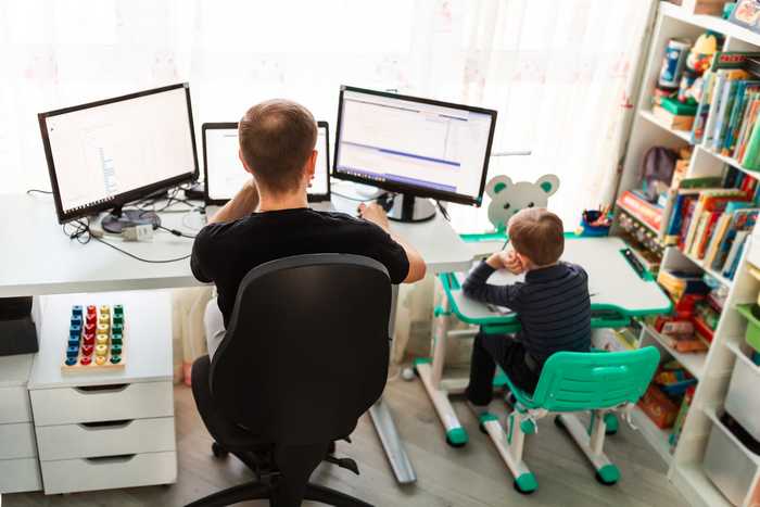 Father working from home with their kid