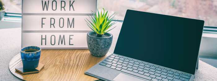 Working from home office space with a laptop on a desk with personal decor