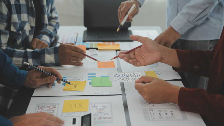 architects over plans and notes