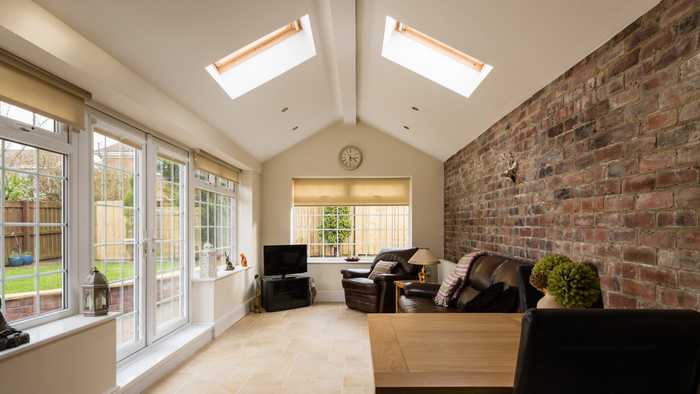 completed home extension with exposed brick wall and patio doors