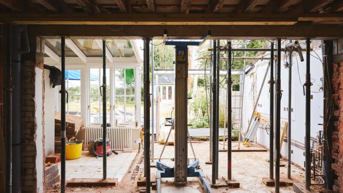 Extension under construction with steel props supporting an opened up rear wall