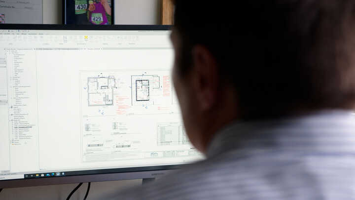 Wouter working on architectural plans.