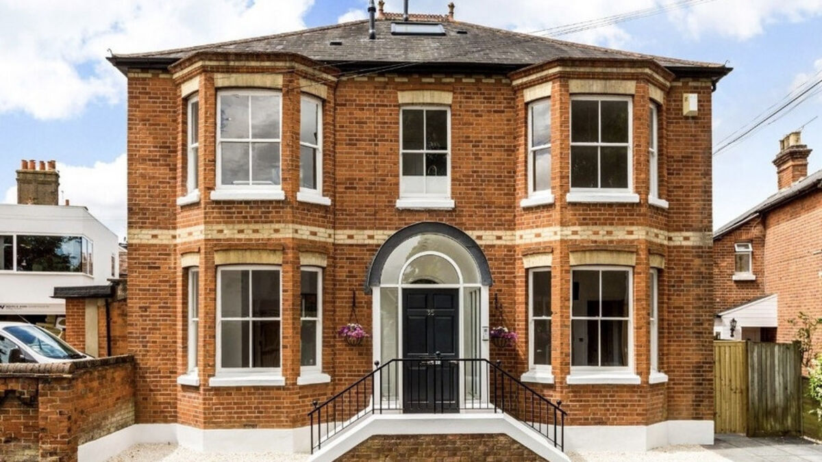 Victorian red brick detached house with bay windows and an arched front door in Maidenhead