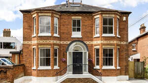 Victorian red brick detached house with bay windows and an arched front door in Maidenhead