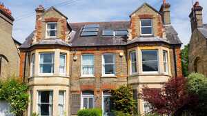Pair of Victorian red brick semi-detached houses with bay windows and front gardens